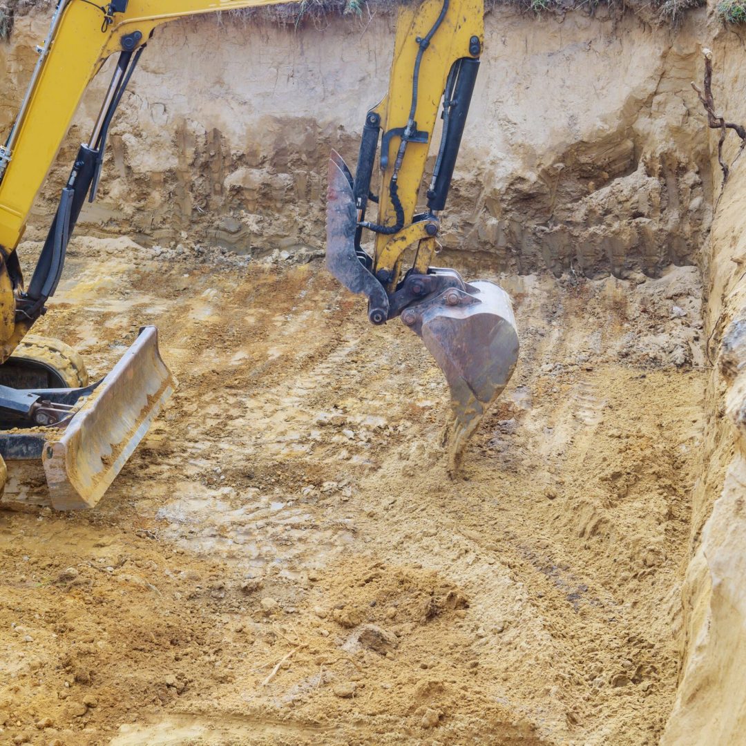 Excavator during earthworks backhoe on work digs ground during earthworks for the foundation