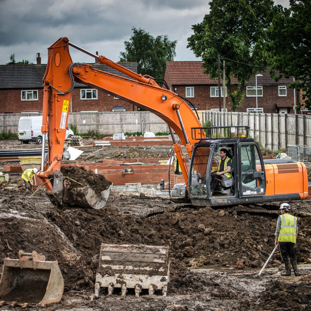 Workers laying bricks on construction site